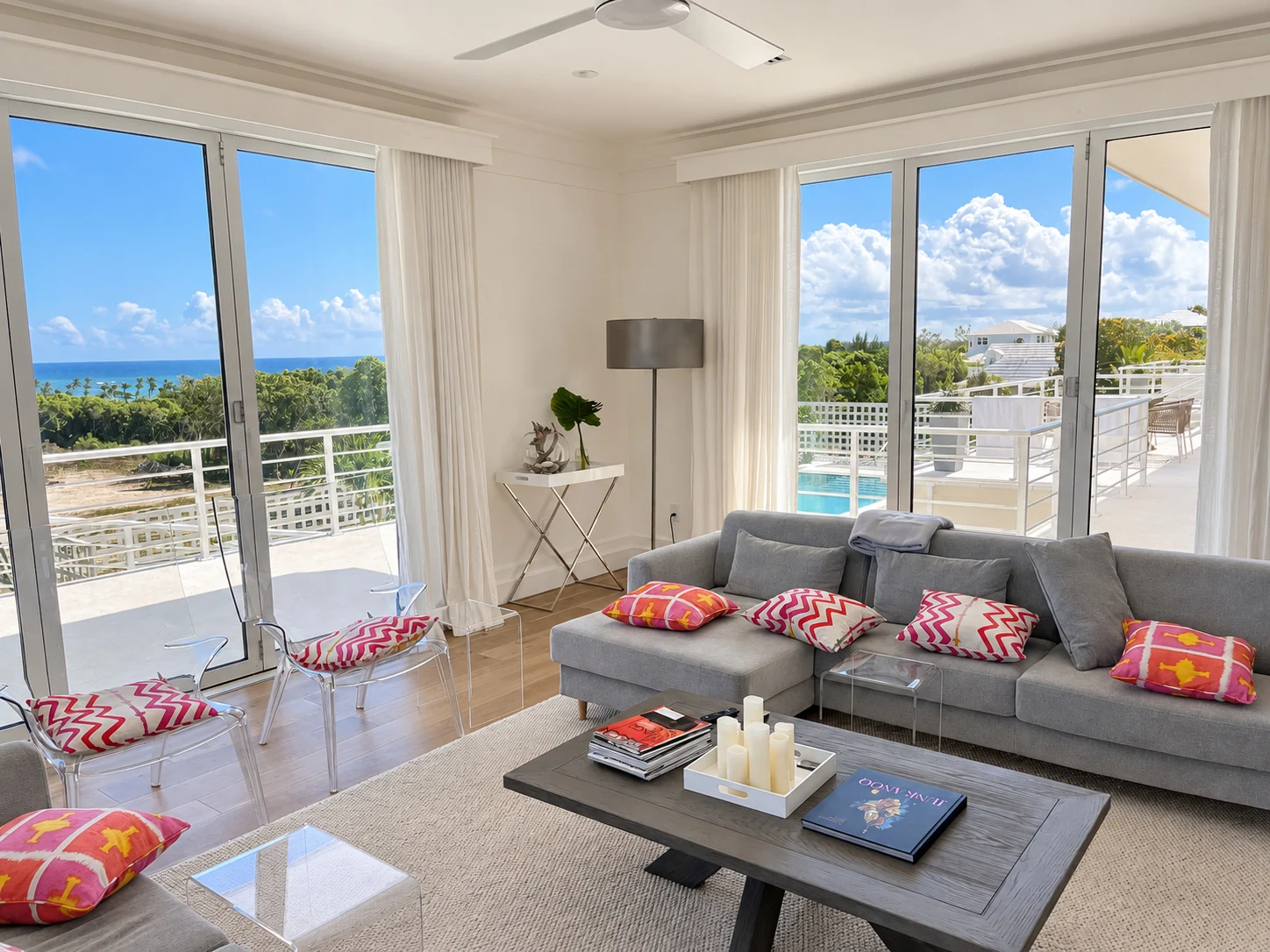 Coastal living room with folding glass doors framing an ocean view