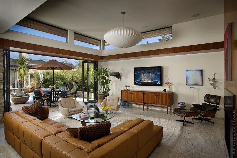 Folding glass doors open onto a furnished outdoor patio