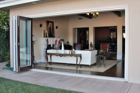 Clad doors folded back to connect a living room with its patio.