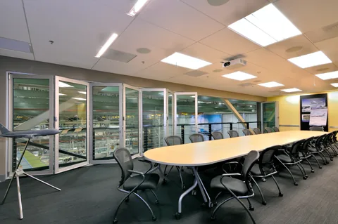 Hurricane aluminum glazing along a bright meeting room.