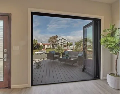 A retractable screen across a folding-door opening to a patio.