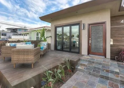 An exterior patio view of a screened folding-door opening.