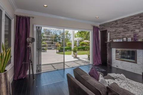 Retractable screening across a living-room opening to the garden.