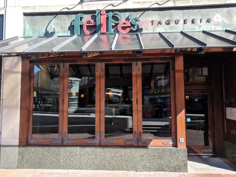 Wood folding doors across a restaurant frontage.