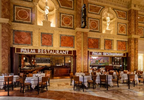 Wood folding glass panels enclosing a restaurant dining area.