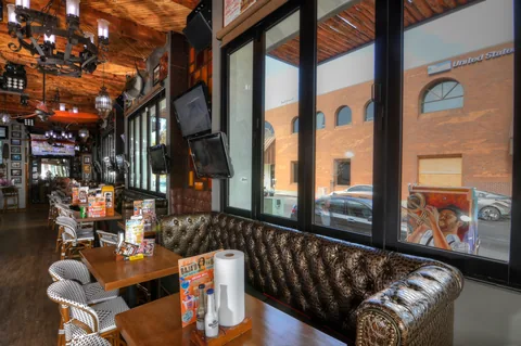 Folded window panels beside booth seating in a restaurant.