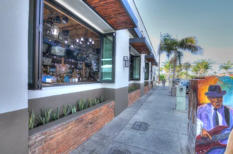 An exterior view of folding windows along a restaurant frontage.