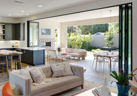 A living room and kitchen opening together onto a covered patio.