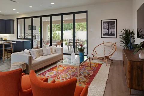 A wide living-room opening next to a folding kitchen window.