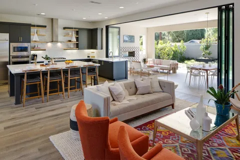 A kitchen pass-through and folding doorway opening onto a shared patio.