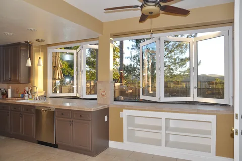 An open kitchen window overlooking an outdoor counter.