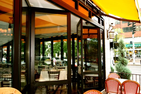 Open folding doors along a restaurant terrace.