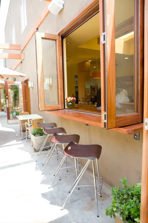 Open wood folding panels beside restaurant seating.