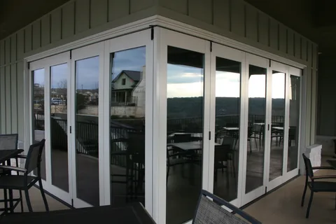 White clad folding panels opening a porch to the outdoors.