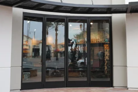 Dark aluminum folding panels set into a radius opening.